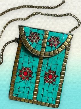Antik Kraft metal mosaic turquoise clutch with chips of red and inlaid gold.